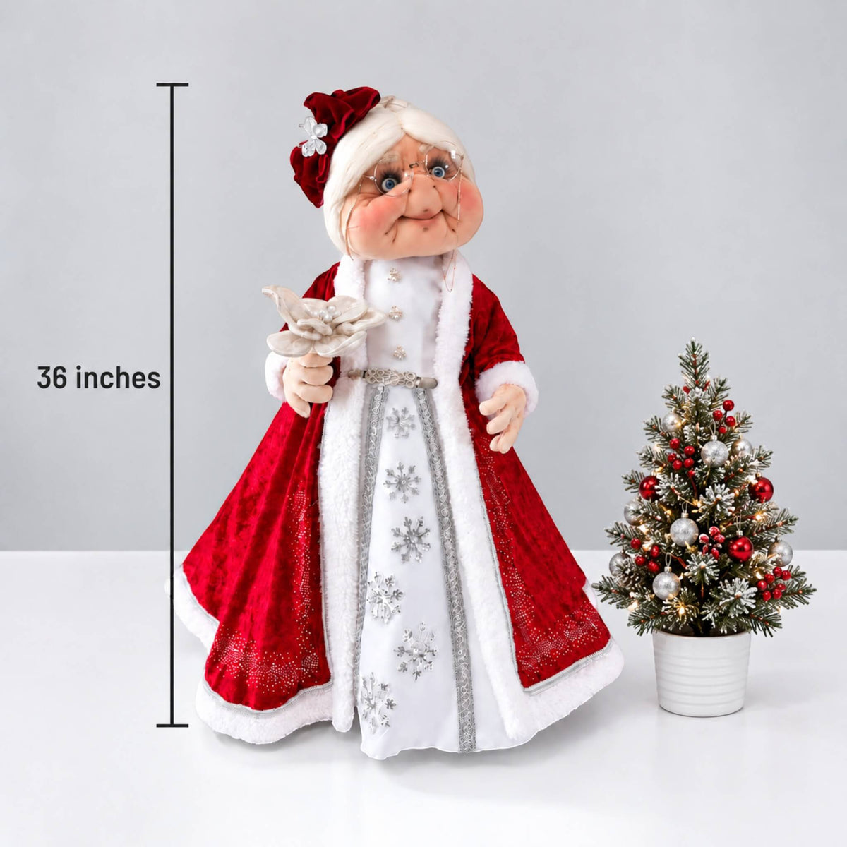 Height comparison of 36-inch Mrs. Claus beside a smaller Christmas tree, with a measurement line.