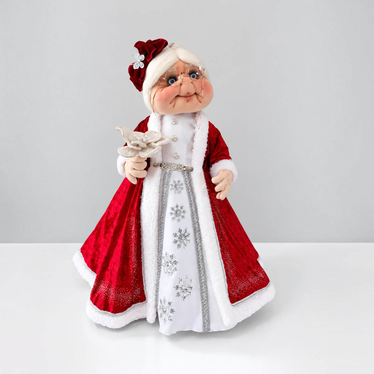 Full front view of 36-inch handmade Mrs. Claus in a red and white dress with silver snowflake details.