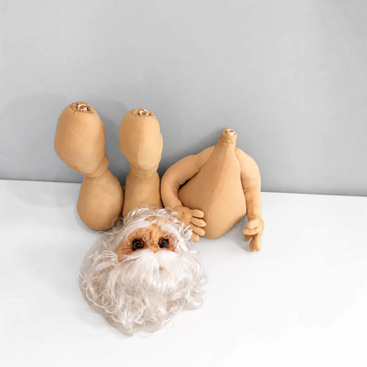 Removable head, torso, and legs of the handmade gold Santa Claus displayed separately.