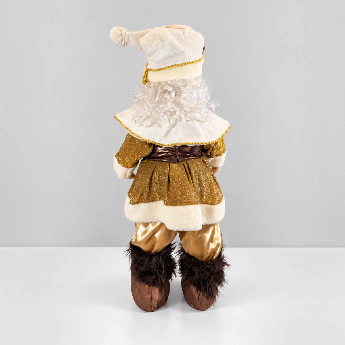 Rear view of a handmade 37-inch Gold Santa Claus Christmas decoration, featuring a glittering gold coat, cream-colored trim, brown waist bow, white curly hair, gold satin pants, and brown faux fur boots.
